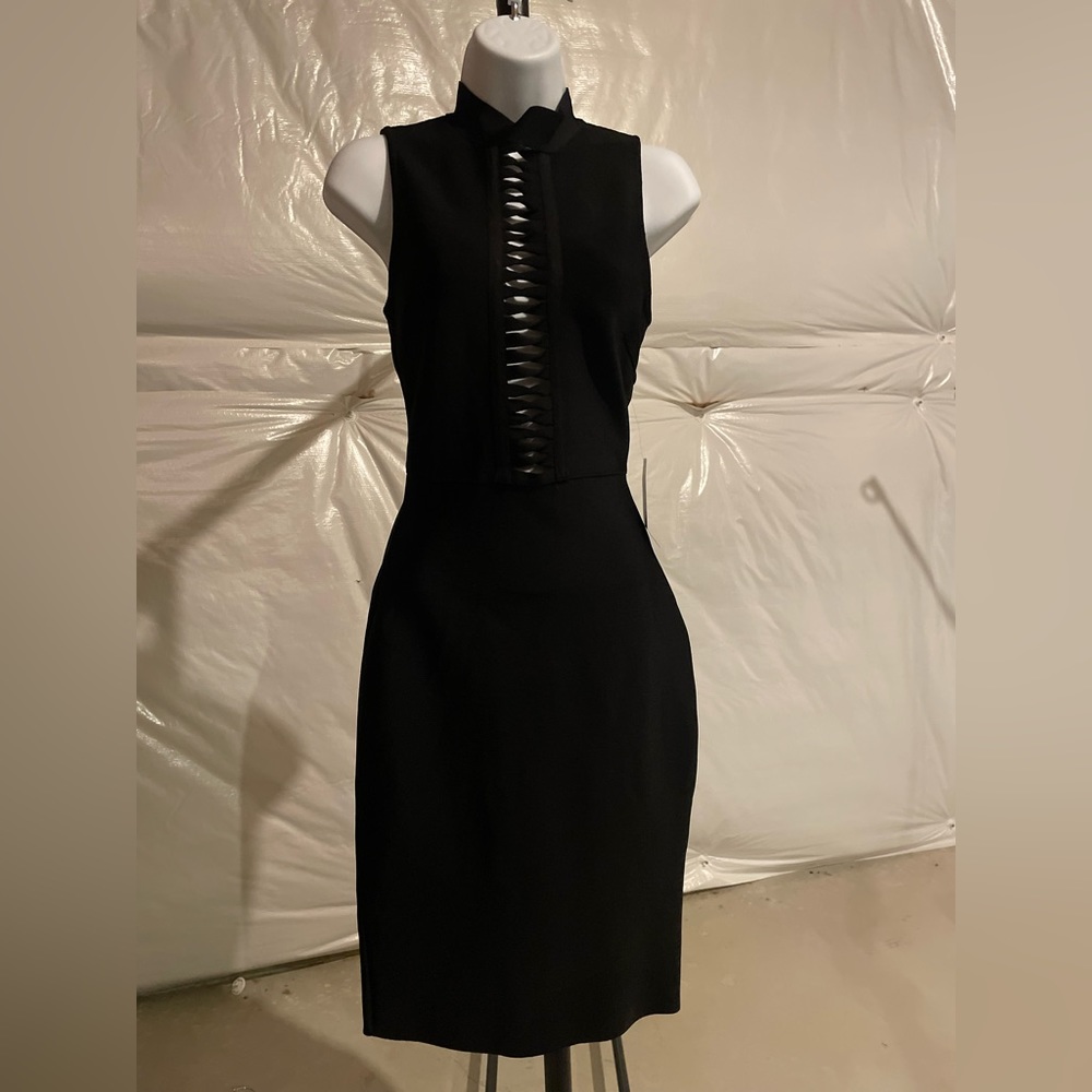 This beautiful black tie dress is 86% Rayon 12% Nylon and 2% spandex.